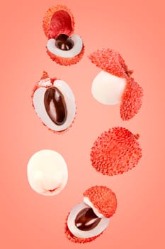 Isolated exotic fruit. Six lychee fruits falling down with clipping path as package design element. Full depth of field. Food levitation concept.