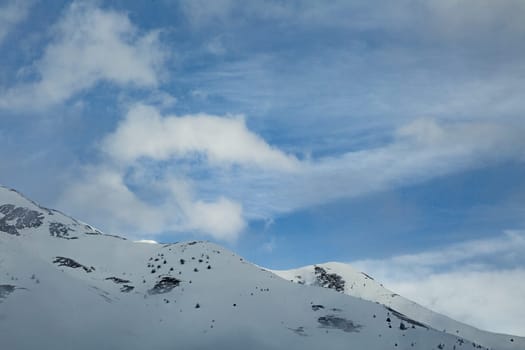 Winter landscape with lots of white snow. Concept of vacation during the winter holidays in the high mountains. Soft focus.