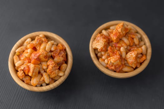 Steamed white beans with meat in tomato sauce. Homemade food concept. Flat lay. Selective focus.