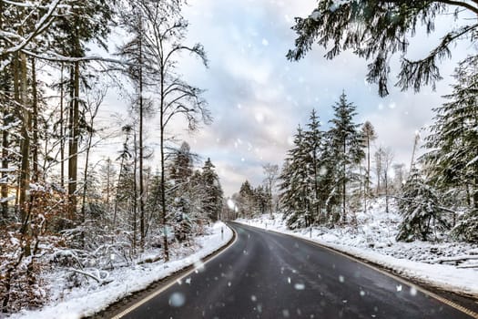Snowy Winter street sourround wood in Germany