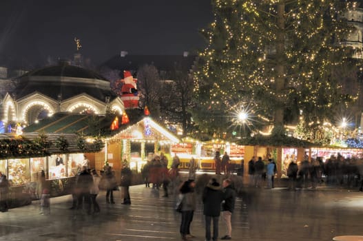 view, at night, of traditional Christmas market held every Advent in streets and squares of city center ..