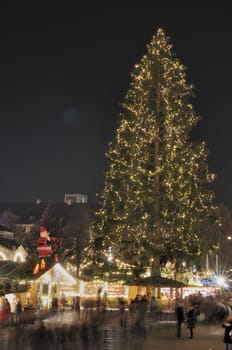 view, at night, of traditional Christmas market held every Advent in streets and squares of city center ..