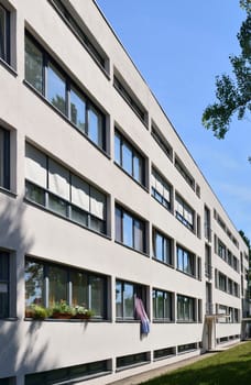 view, from the public street, of the house built in twenties by the famous architect in the residential quarter established according to the standards of modern architecture, shot in sunny weather