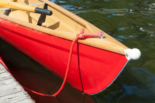 Bow of a red rowing boat with rubber nose