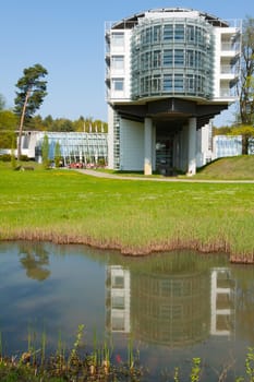 Hotel wing is reflected in a pool