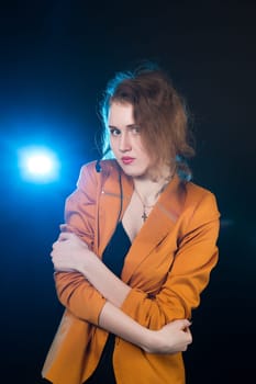 Young beautiful woman-operator with headphone smiles, it is isolated on black background.