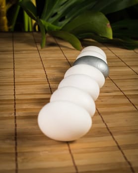 Silver and white Easter eggs with wood background