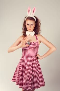 sexy girl wearing easter bunny costume with egg
