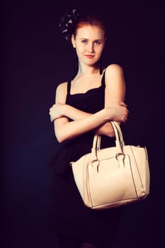 Pretty young woman with big white bag standing posing