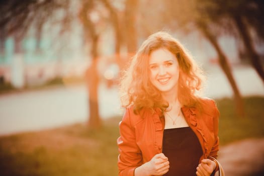 young curly Woman  smiling, on sunset