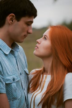Happy young couple kissing on a ripe field
