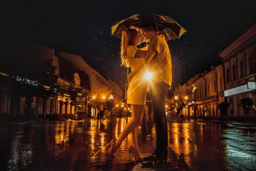 Love in the rain / Silhouette of kissing couple under umbrella