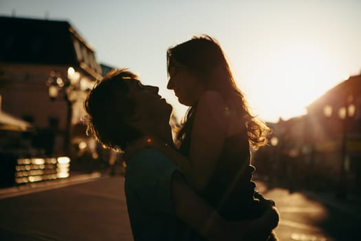 Young couple kissing over sunset