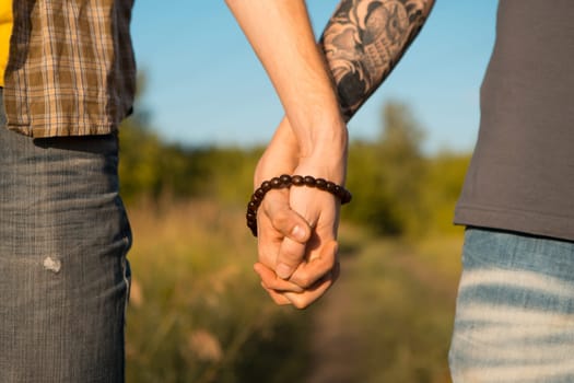 Image of two men Holding hands at gay Wedding