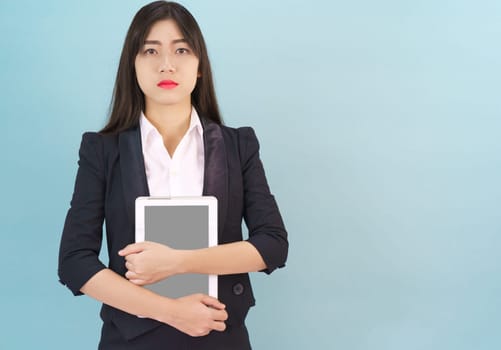 Young women standing in suit holding her digital tablet computor