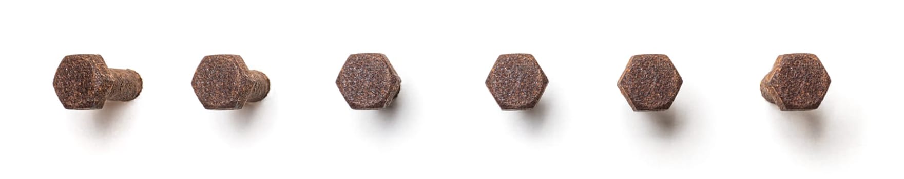 Rusty hex bolt from different perspectives on a white background