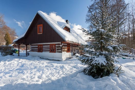 Traditional wooden cottage in winter. Czech republic
