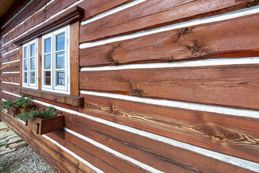 Traditional old wooden cottage in winter. High quality photo.