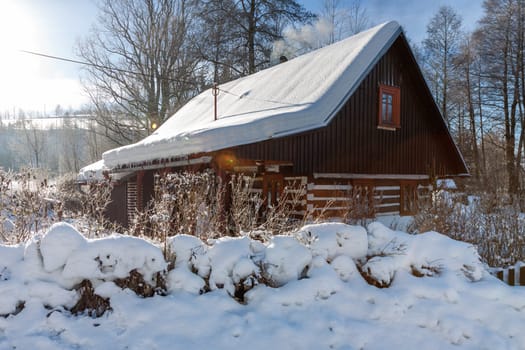 Traditional wooden cottage in winter. Czech republic
