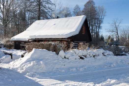 Traditional wooden cottage in winter. Czech republic