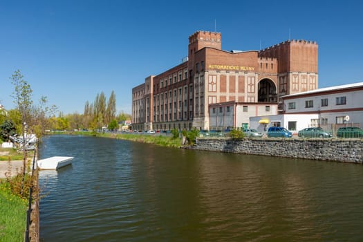 PARDUBICE, CZECH REPUBLIC - APRIL 22: Building Automatic mills Pardubice on April 22, 2016. An important monument of industrial architecture from 1910 by architect Josef Gocar. River Chrudimka.
