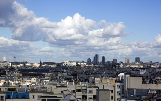 The rooftops of Paris under a threatening sky. Haussmannian architecture and modernity. (Paris, France)