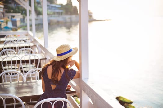 Girl sits in a beautiful summer cafe Bulgaria, Nessebar