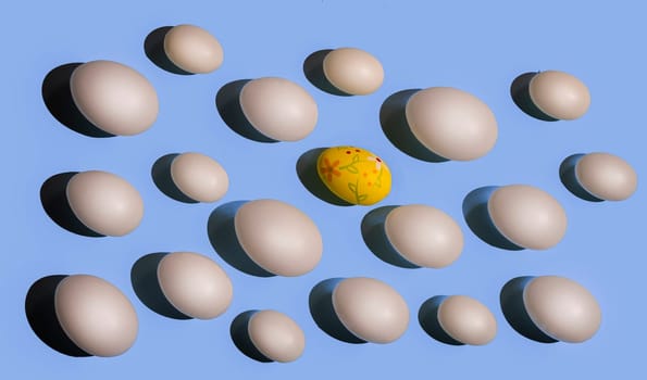A recorated Easter egg  among some white eggs