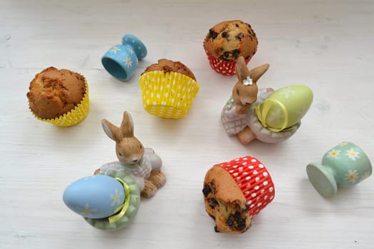 Easter decoration with muffins, eggs and rabbits. Easter bunnies. Vintage style