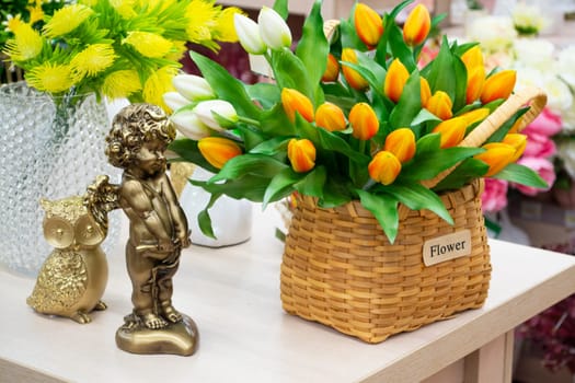 Vintage table with angel, clocks and basket of retro fake tulips