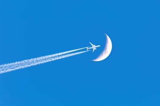 Passenger plane - airliner passes near the moon. Explore new frontier. Space traveler concept