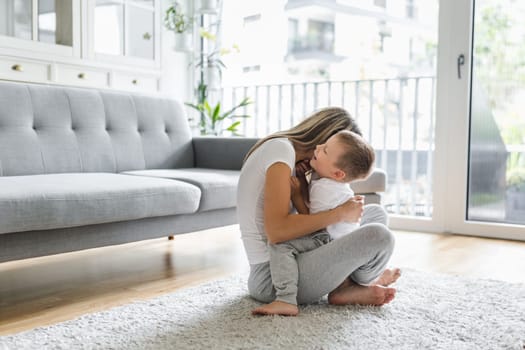 Mother with her son playing in their living room