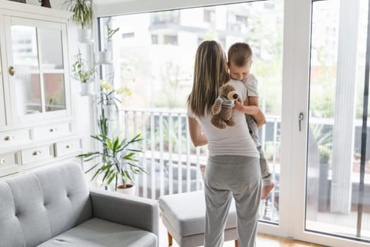 Mother with her son playing in their living room