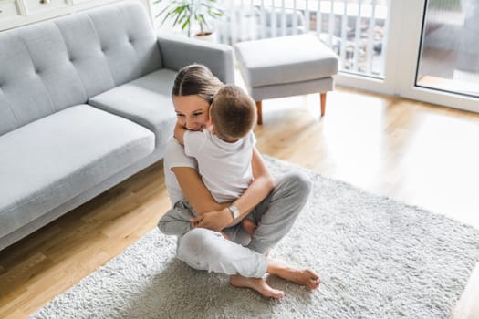 Mother with her son playing in their living room
