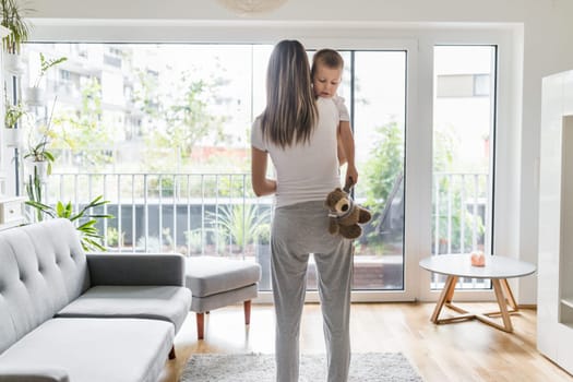 Mother with her son playing in their living room
