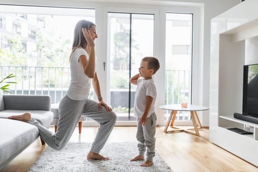 Mom with her young son working out in the living room