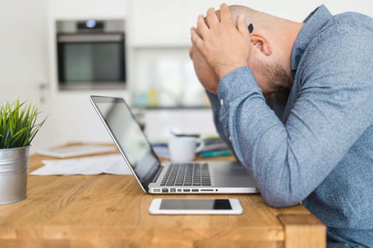 Unhappy man working from his home during the pandemic