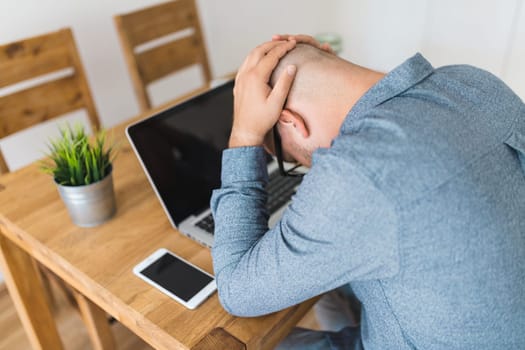 Unhappy man working from his home during the pandemic