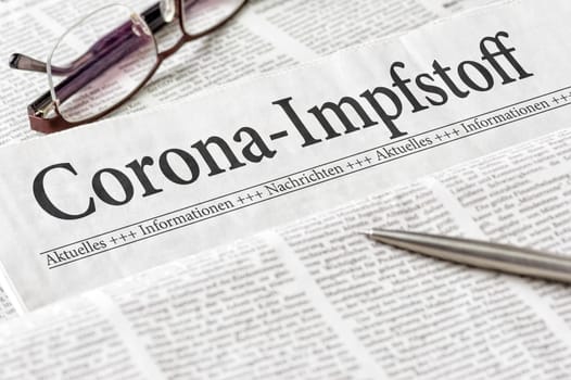 A newspaper with the headline Coronavirus Vaccine in german - Corona-Impfstoff