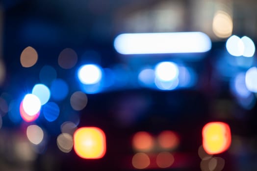 Detail of Blurred emergency background with blue lights in the city at night