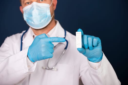 Doctor holding a test kit for viral disease COVID-19. Lab card kit tested NEGATIVE for viral novel coronavirus sars-cov-2 virus.