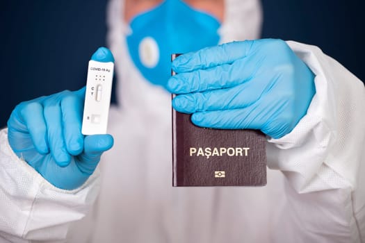 Doctor holding passport and negative covid-19 ( rapid antigen SARS-CoV-2 Ag ) test. Coronavirus and safety travel concept.
