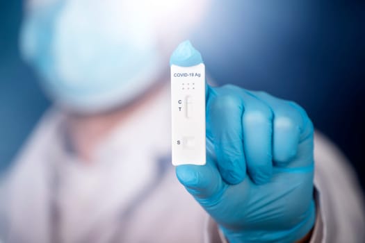 Doctor holding a test kit for viral disease COVID-19. Lab card kit tested NEGATIVE for viral novel coronavirus sars-cov-2 virus.