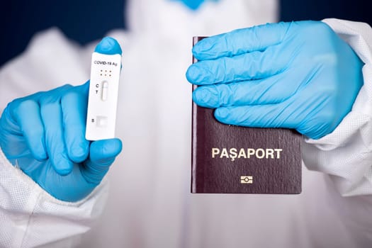 Doctor holding passport and negative covid-19 ( rapid antigen SARS-CoV-2 Ag ) test. Coronavirus and safety travel concept.