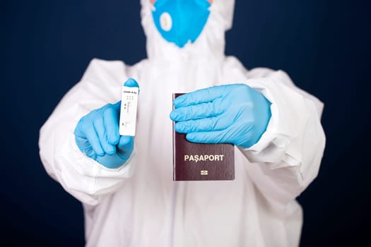 Doctor holding passport and negative covid-19 ( rapid antigen SARS-CoV-2 Ag ) test. Coronavirus and safety travel concept.