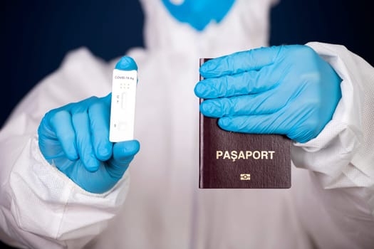 Doctor holding passport and negative covid-19 ( rapid antigen SARS-CoV-2 Ag ) test. Coronavirus and safety travel concept.