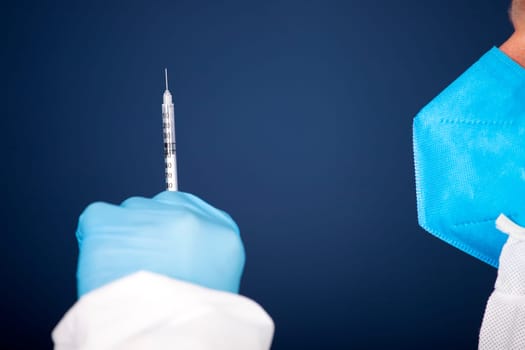 Concept of herd immunity, virus spreading in society. Doctor with syringe is preparing for vaccine.