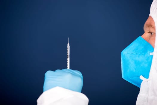 Concept of herd immunity, virus spreading in society. Doctor with syringe is preparing for vaccine.