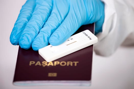 Doctor holding passport and negative covid-19 ( rapid antigen SARS-CoV-2 Ag ) test. Coronavirus and safety travel concept.