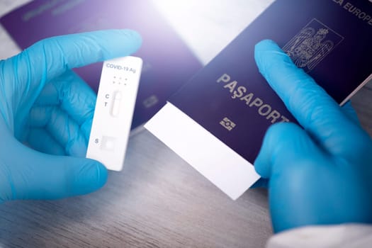 Doctor holding passport and negative covid-19 ( rapid antigen SARS-CoV-2 Ag ) test. Coronavirus and safety travel concept.